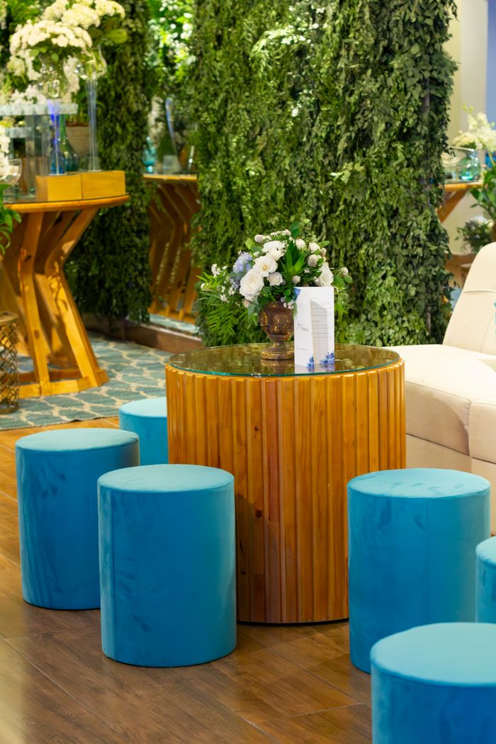 The Art of Drawing Readers In: Your attractive post title goes here Stylish indoor wedding reception setup with blue seating and floral arrangements, perfect for a São Paulo event.